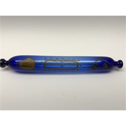 19th century Bristol blue glass rolling pin, with printed and gilt decoration of a schooner, crossed union flags, and inscription 'I wish you well', L36cm, together with another 19th century green glass example, L39cm