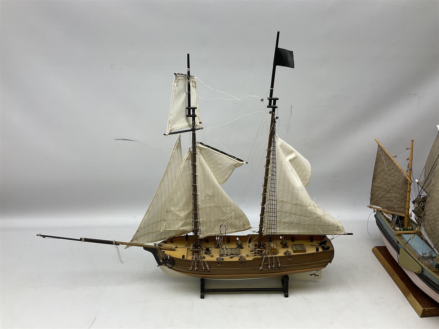 Eight model ships or boats including fishing boat with fish, nets and buoyancy aid, two mast sailing ship complete with cannons, two mast yacht with detailed rigging and life boat etc, the largest L72cm, H60cm