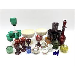 A group of Victorian glassware, to include Ruby flashed decanter and six glasses, decanter H25cm, five further drinking glasses with green bowls, a dump paperweight, and miniature painted milk glass teawares, two slag glass pedestal bowls, four slag glass tumblers, plus a small selection of later glassware including an amber glass Isle of Man 1892 exhibition compressed tumbler. 