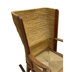 Reynold Eunson (1932–1978) for David Munro Kirkness, Kirkwall, Orkney - oak framed Orkney rocking chair, woven straw curved back, drop-in rush seat, the arm terminals with carved end scroll, on square tapering supports joined by plain stretchers, the front rail inscribed with makers marks