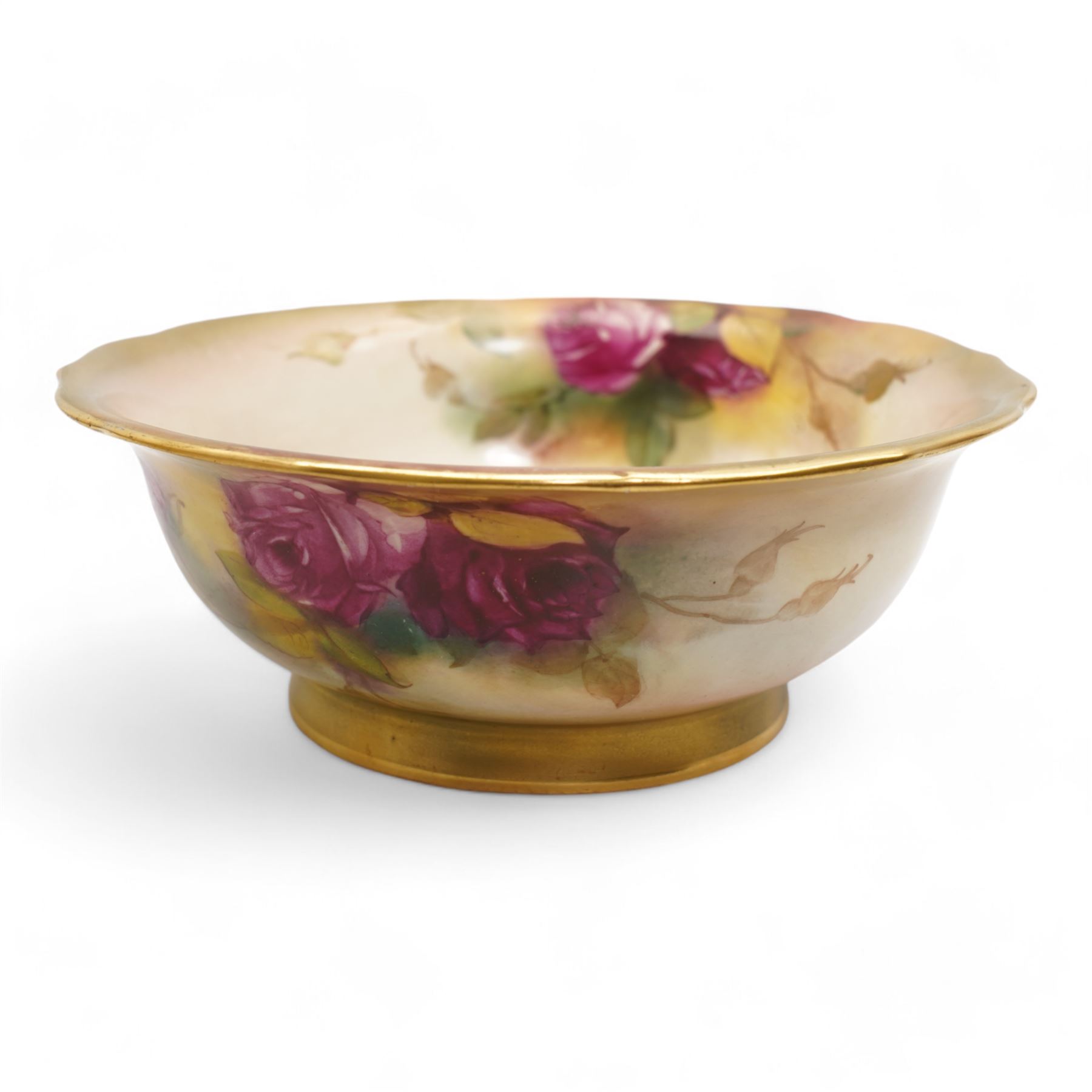 1920s Royal Worcester porcelain rose bowl, the flattened baluster body hand painted with roses and foliage, below a flared gilt pierced border, raised upon scroll moulded quatrefoil foot, shape no. H166, H13cm, together with a similarly decorated Royal Worcester bowl (2)