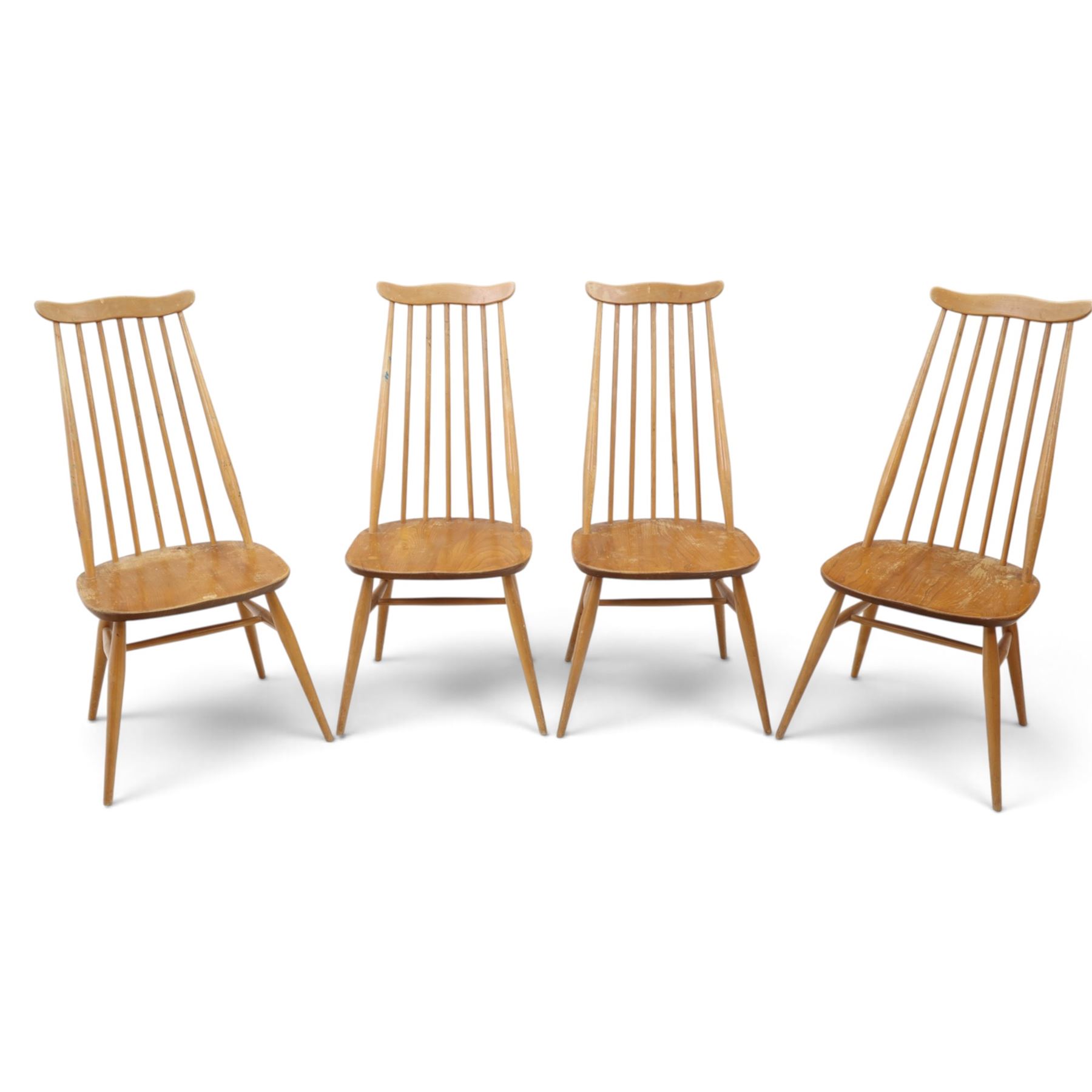 Ercol - 'Goldsmith' light elm set of four dining chairs, shaped cresting rail above seven spindles, dished seat raised on tapering supports with H-stretcher