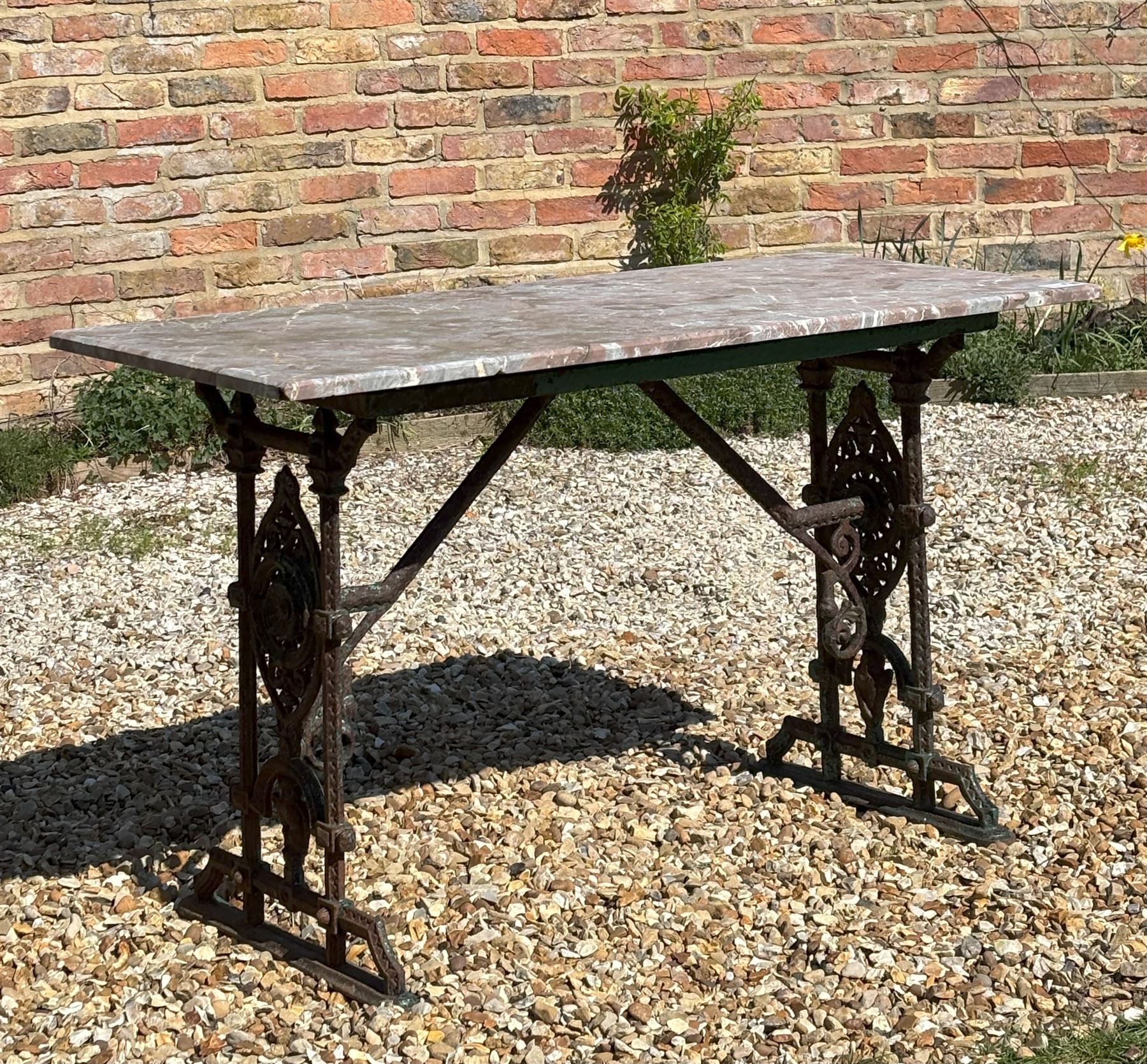 Victorian cast iron garden table, the base with oval cartouches and owl motif supporting an associated variegated rouge marble top. H72cm, L91cm, D46cm.  - COLLECTION BY APPOINTMENT FROM: The White House, Thirsk Road, Easingwold, York, YO61 3NF - CALL 01723 507111 TO ARRANGE