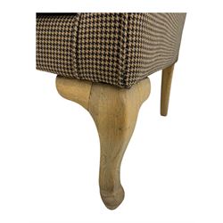 Hardwood-framed wingback armchair, upholstered in dog tooth pattern fabric, on cabriole supports 