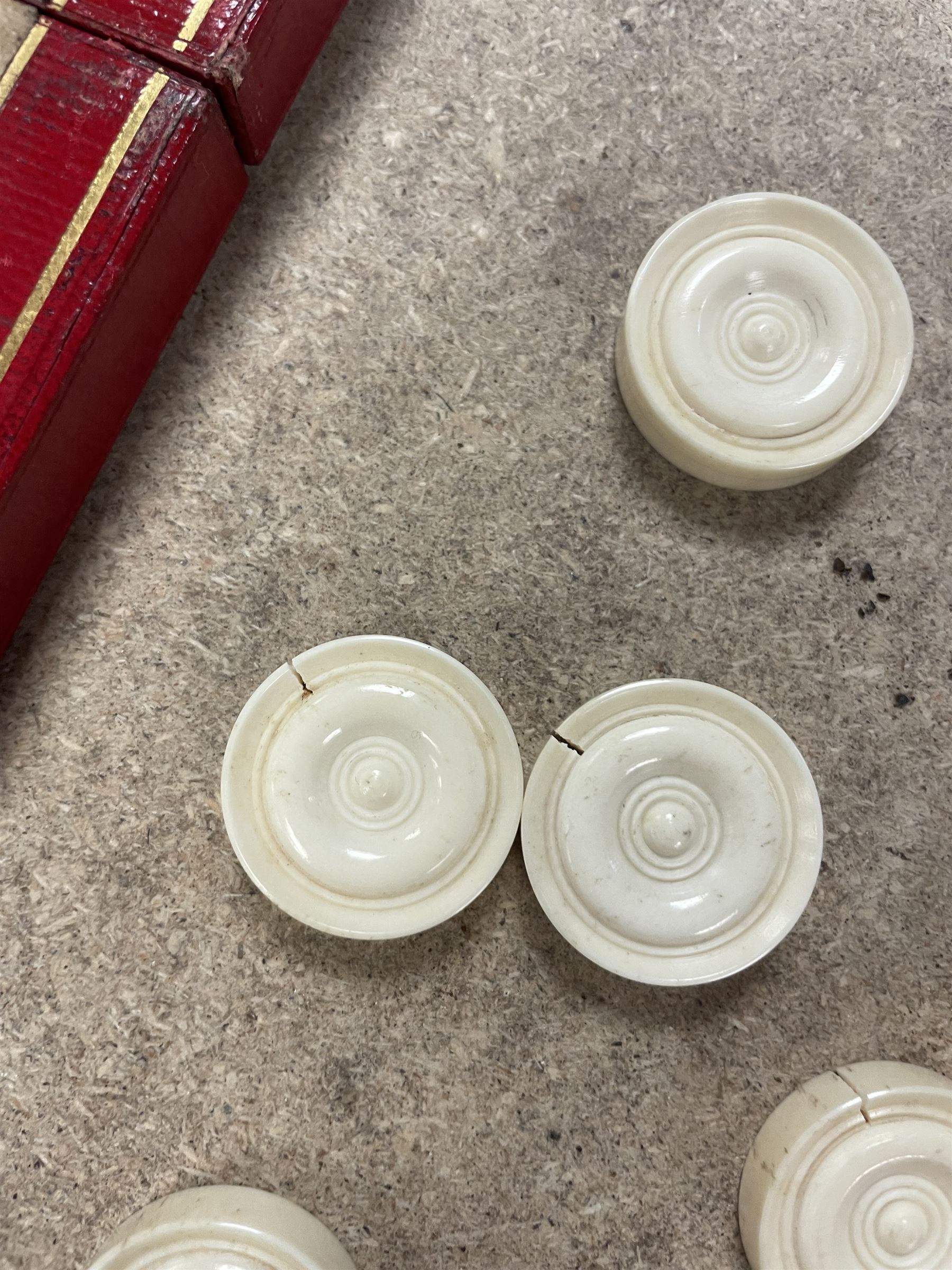 19th century walnut and brass bound games compendium box, painted to enhance the grain, of rectangular form, the hinged opening cover with rounded sides, central brass cartouche with engraved lion crest, and brass riveted straps, opening to reveal a red leather and blue silk lined compartmented interior, with fold-down games board, and lift-out tray containing playing cards, ebony turned dice towers, white and red stained bone draughts, and chess pieces, ivory dice, and ivory and ebony whist markers, and brass bezique board, cribbage board and markers, H15cm W32cm D24cm
This lot has been registered for sale under Section 10 of the APHA Ivory Act