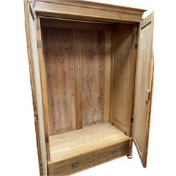 Late 19th century pine wardrobe, enclosed by two panelled doors, drawer to base