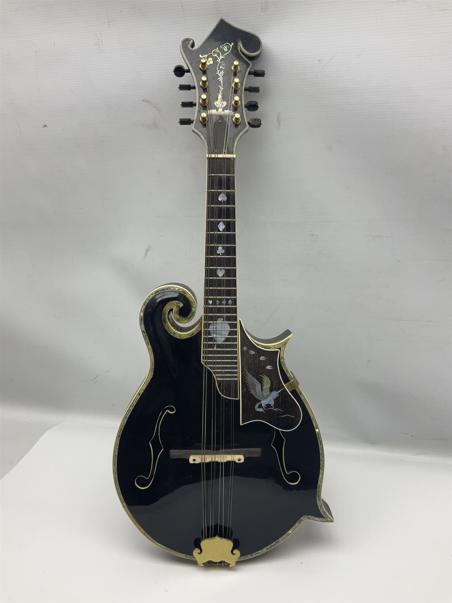 Eastern F-hole eight-string mandolin with black finish and mother-of-pearl inlay of a man riding a winged horse/unicorn amongst clouds and stars with playing card suits to the fingerboard L71cm