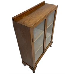 Mid 20th century oak bookcase, fitted with two glazed doors