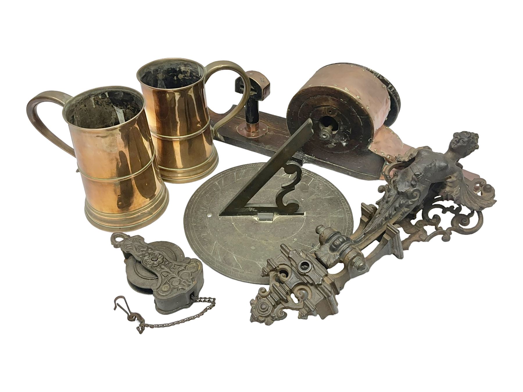 Two 19th century copper tankards, one with weighted wooden base, together with copper and wooden mechanical bellows, sundial and other metalware 