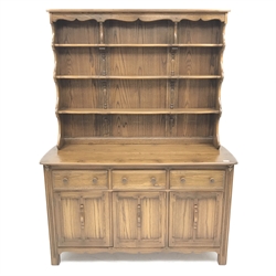 Ercol Old Colonial elm dresser, Golden Dawn finish, raised three tier plate rack above three drawers and three cupboards, stile supports, W147cm, H193cm, D52cm