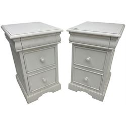 Pair of white painted bedside chests, fitted with secret top drawer, above two short drawers, on bracket feet