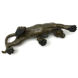 A bronze figure, modelled as a cougar in crouching pose, signed Milo and with foundry mark, L40cm.
