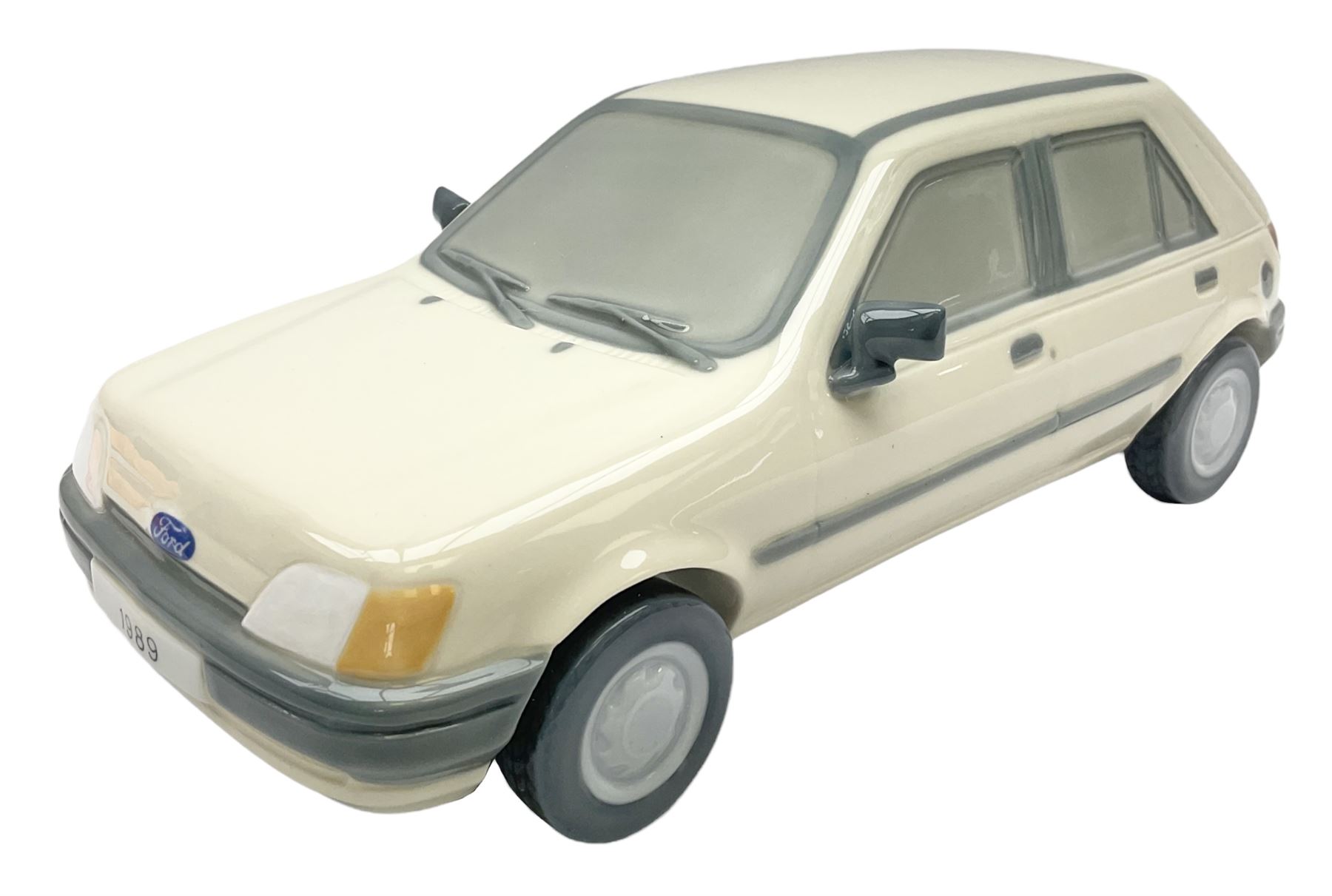 Lladro figure, Ford Fiesta, modelled as a Ford in beige, special commission by the Ford factory in Valencia, original box, no 7608, year issued 1989, year retired 1989, H9cm 