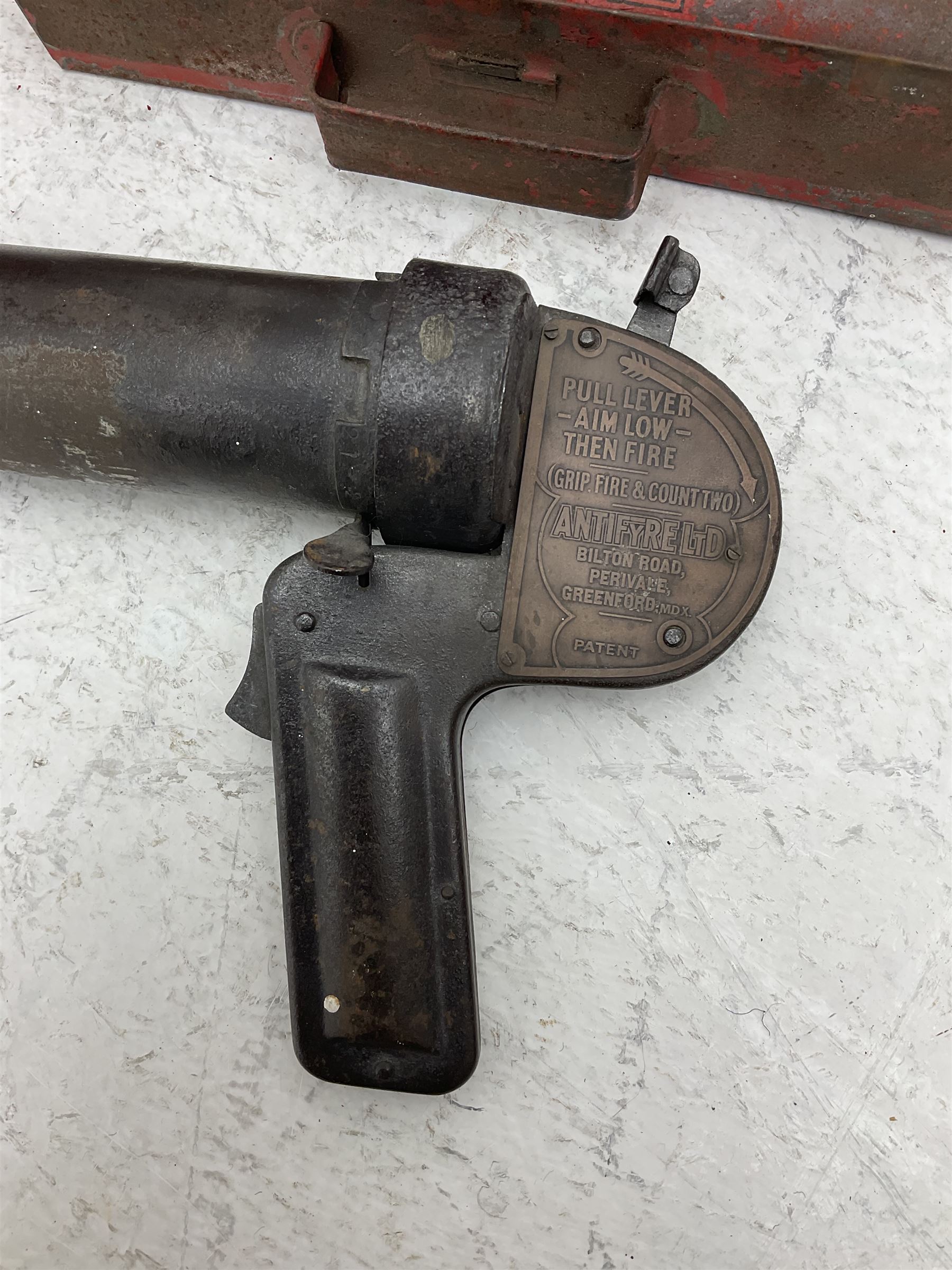 Antifyre Pistole fire extinguisher grenade launcher together with four cartridges (one lacking contents) in original storage tin, together with a red painted fire bucket