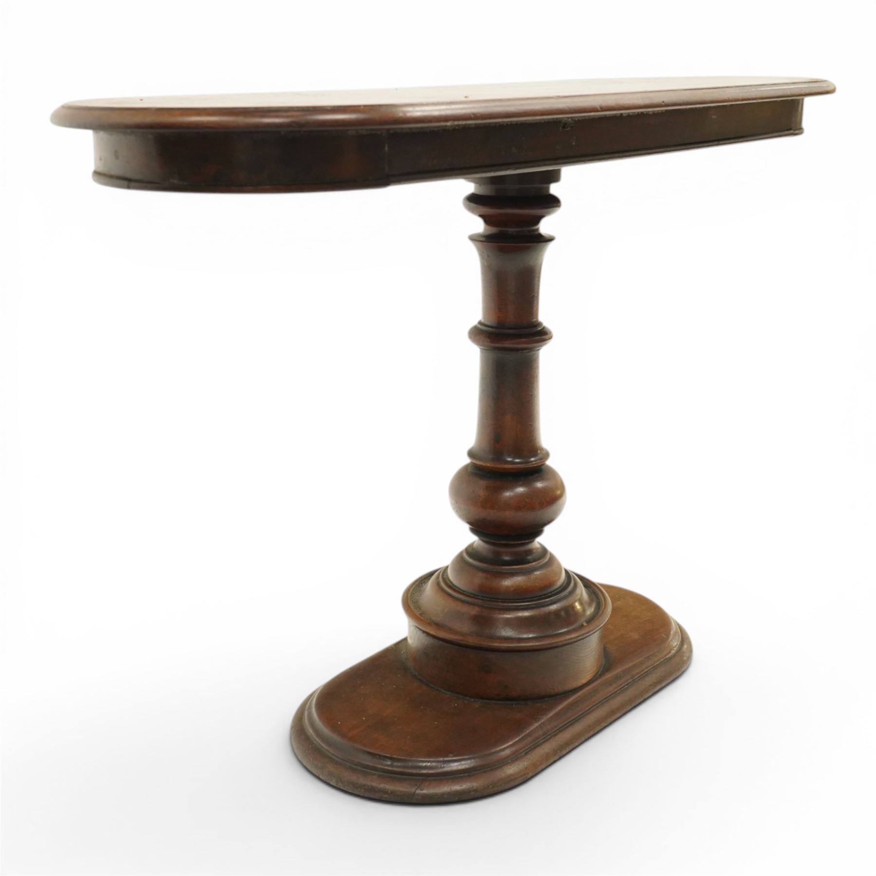 Georgian mahogany console table, the top of oval form, above a turn vasiform column, above an oval plinth base 