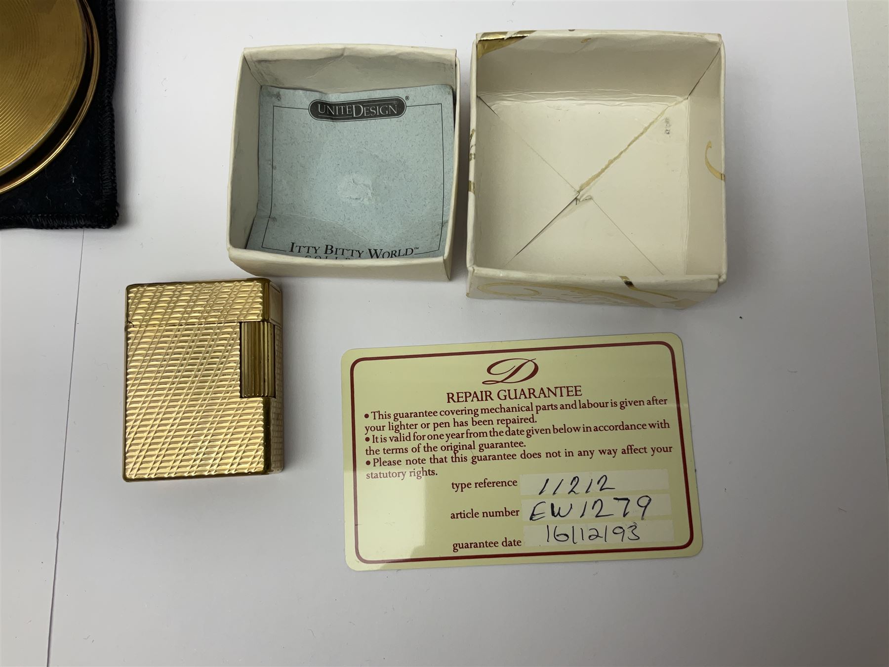 St Dupont gold plated cigarette lighter, with engine turned decoration, serial no EW1279, together with three powder compacts, including Stratton and Regent of London examples