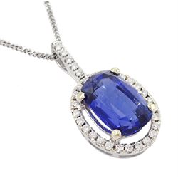 18ct white gold sapphire and diamond halo pendant necklace, single cushion cut sapphire of approx 4.65 carat, with round brilliant cut diamond surround and bail, on fine flattened curb link chain necklace, both hallmarked, total diamond weight approx 0.35 carat