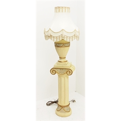 A composite cream Ionic column stand, H68cm, together with a matching table lamp of baluster form with cream tasselled shade, including shade H70cm. 