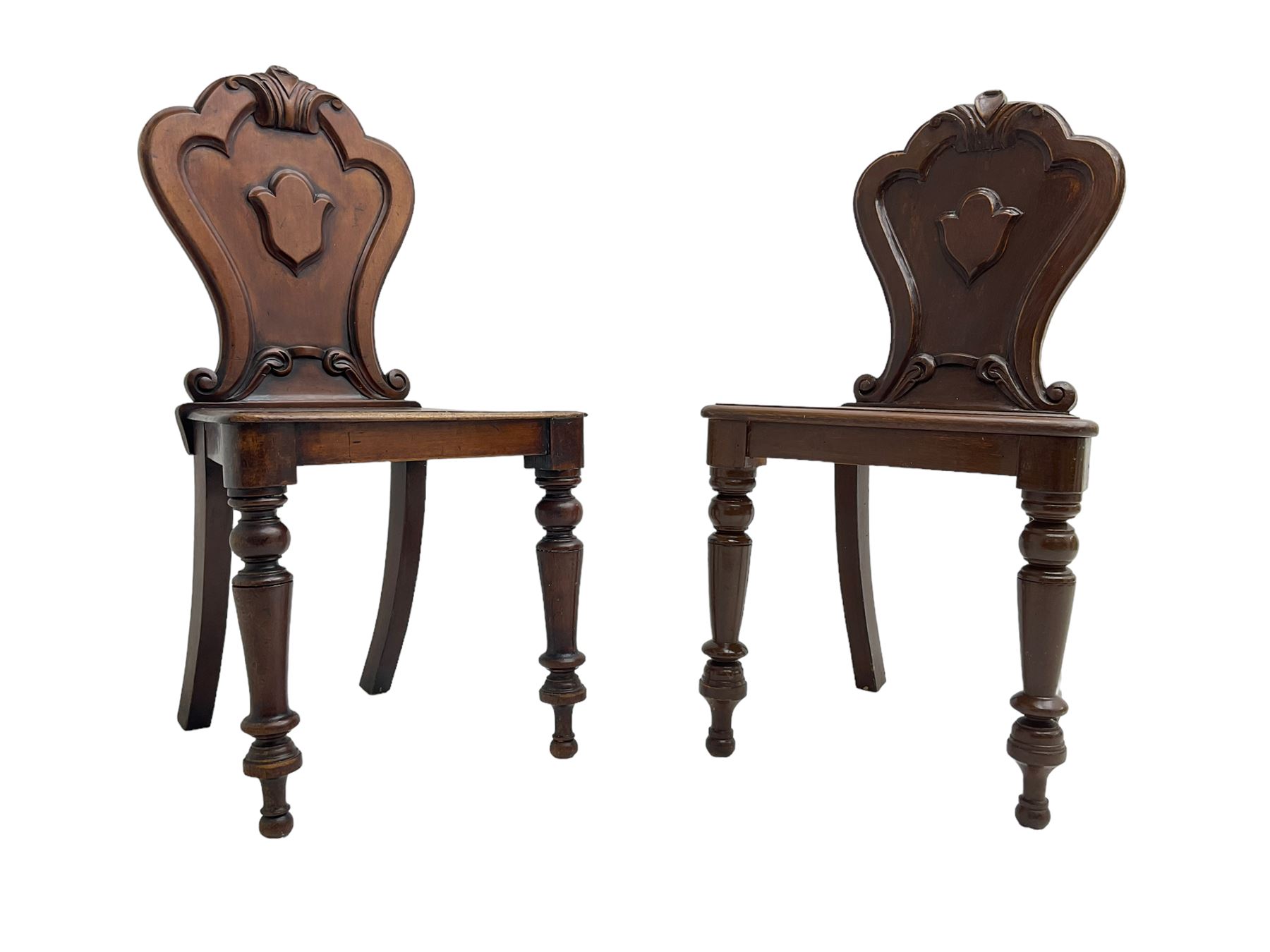 Pair of Victorian mahogany hall chairs, shaped moulded back carved with cartouche, moulded seat on turned front supports