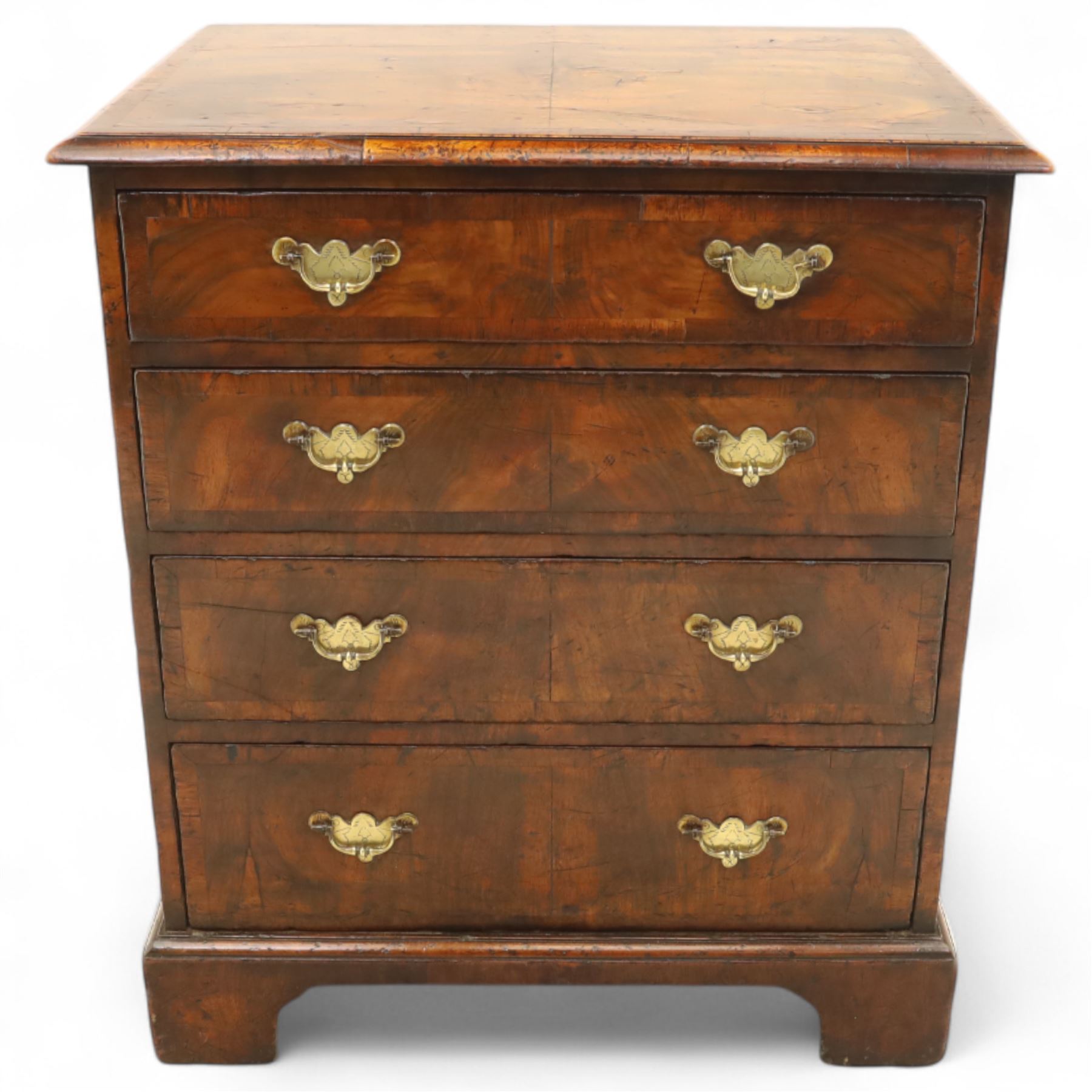 Small 19th century figured walnut chest of drawers, rectangular top with moulded edge over four graduating drawers with brass batwing handles, raised on bracket feet