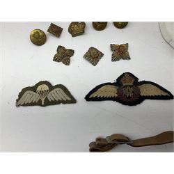 WW2 RAF sidecap dated 1942 with badge and buttons; quantity of RAF metal and cloth badges, pips and buttons; and paratrooper's helmet chin strap