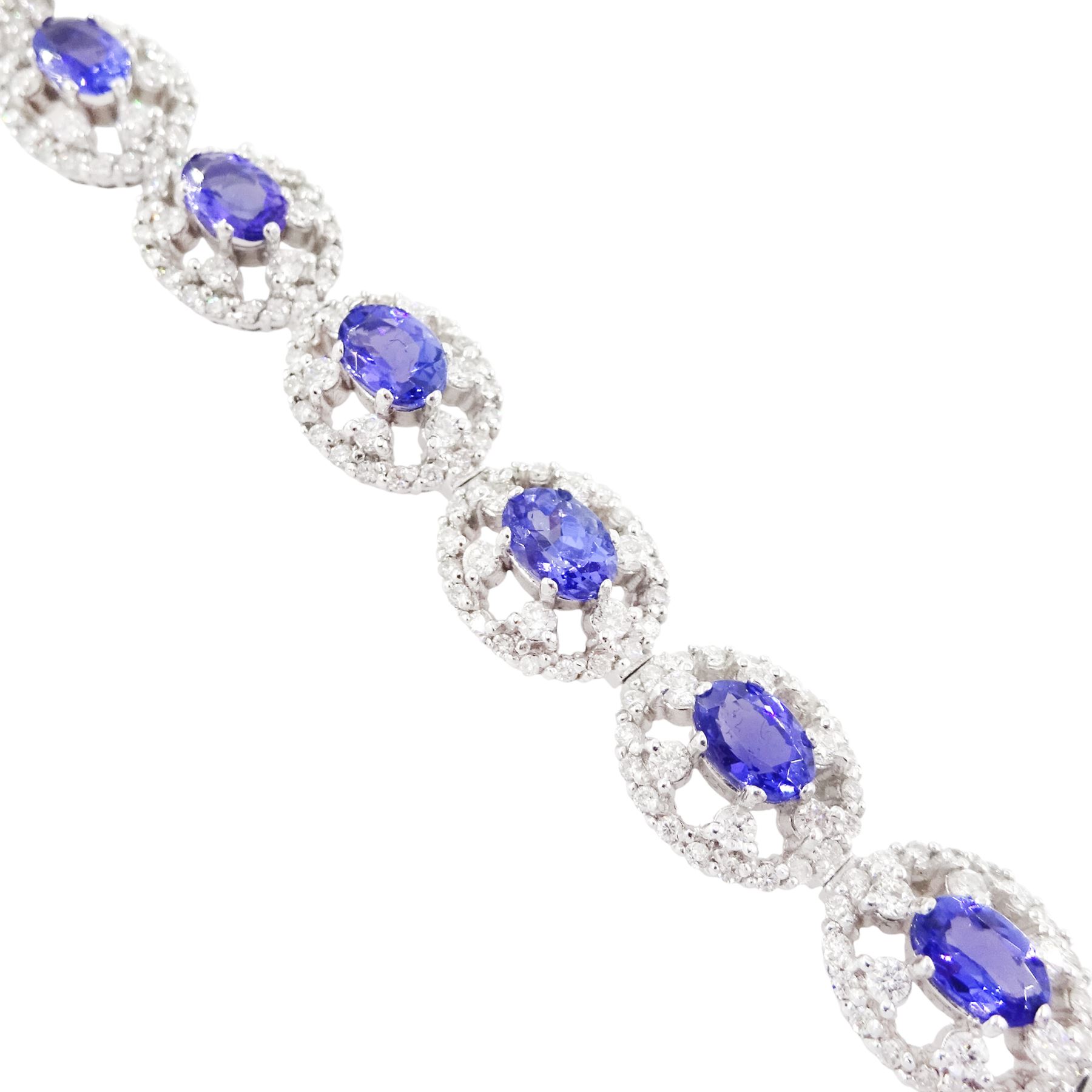 18ct white gold tanzanite and diamond bracelet, twelve oval link clusters set with oval cut tanzanite's and round brilliant cut diamonds, stamped 750, total tanzanite weight approx 7.15 carat, total diamond weight approx 4.00 carat