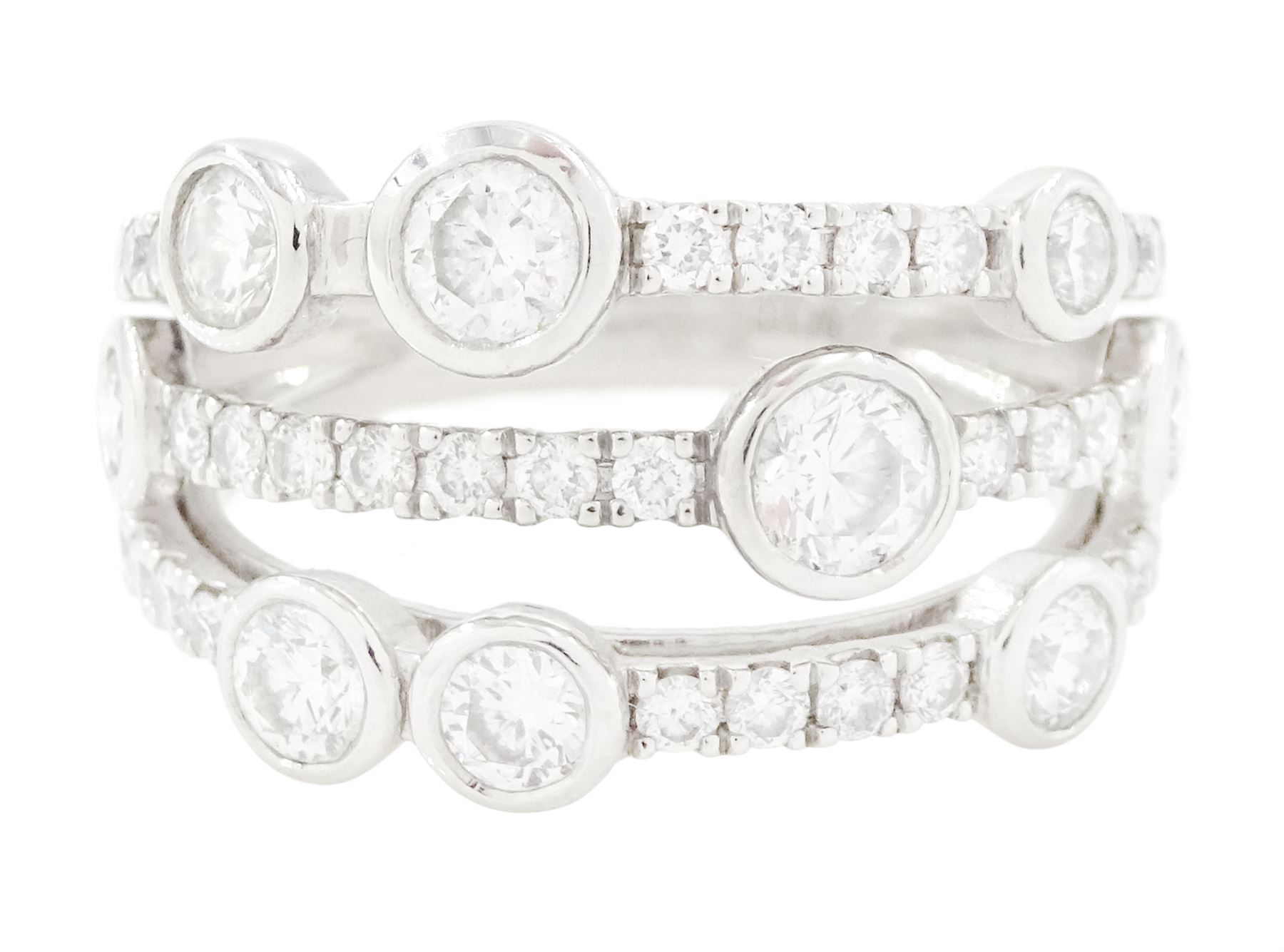 Platinum diamond three row split design ring, nine bezel set round brilliant cut diamonds, spaced by smaller round brilliant cut diamonds, hallmarked, total diamond weight 1.70 carat 