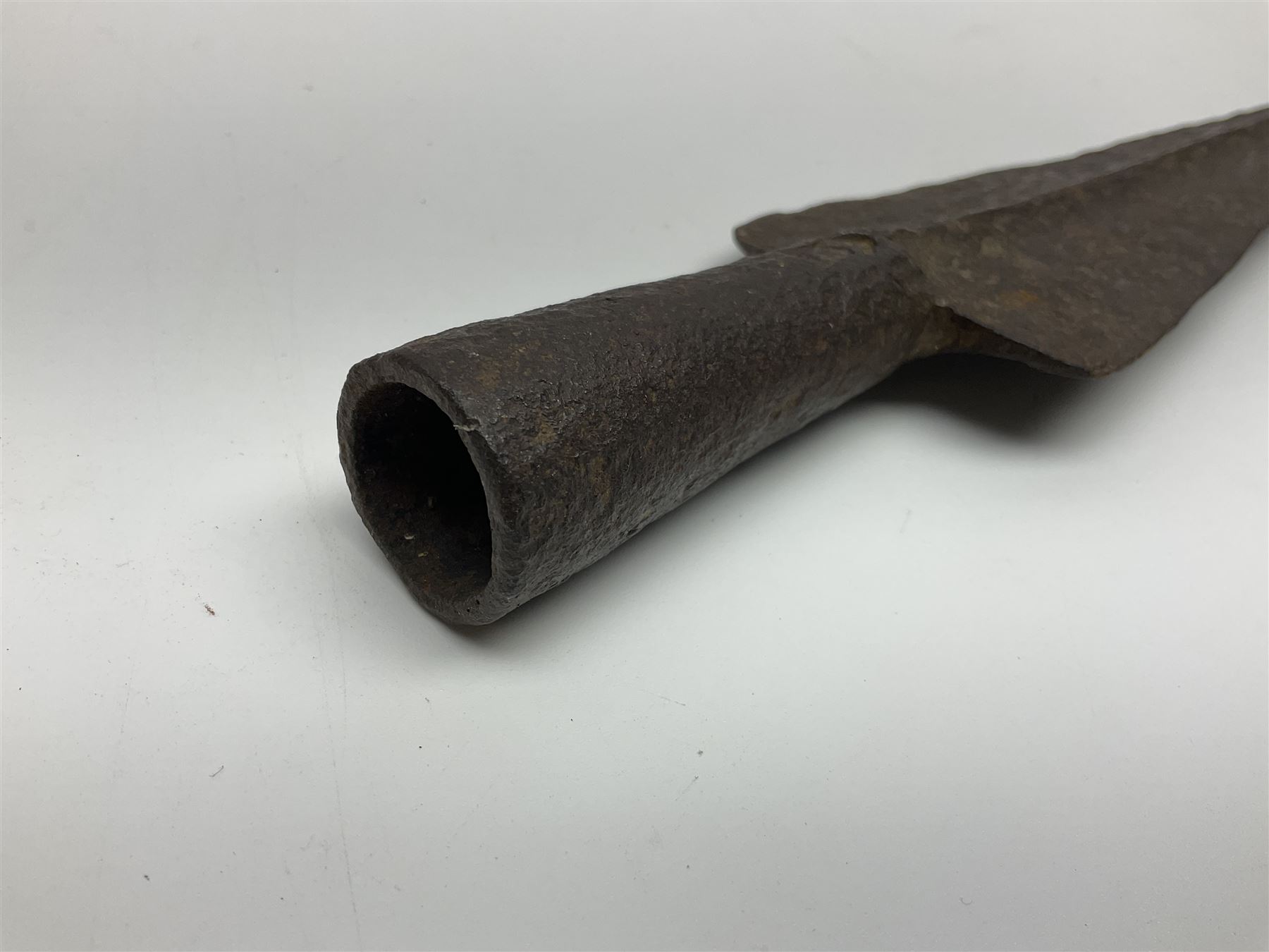 19th century continental folding knife with 15.5cm single edged blade, the pierced brass and iron handle with remains of horn grips L21.5cm overall closed; turned horn handled knife with foliate engraved blade; battlefield relic German 1884/98 knife bayonet; iron spear head; leather covered swagger stick; and two-piece gun cleaning rod