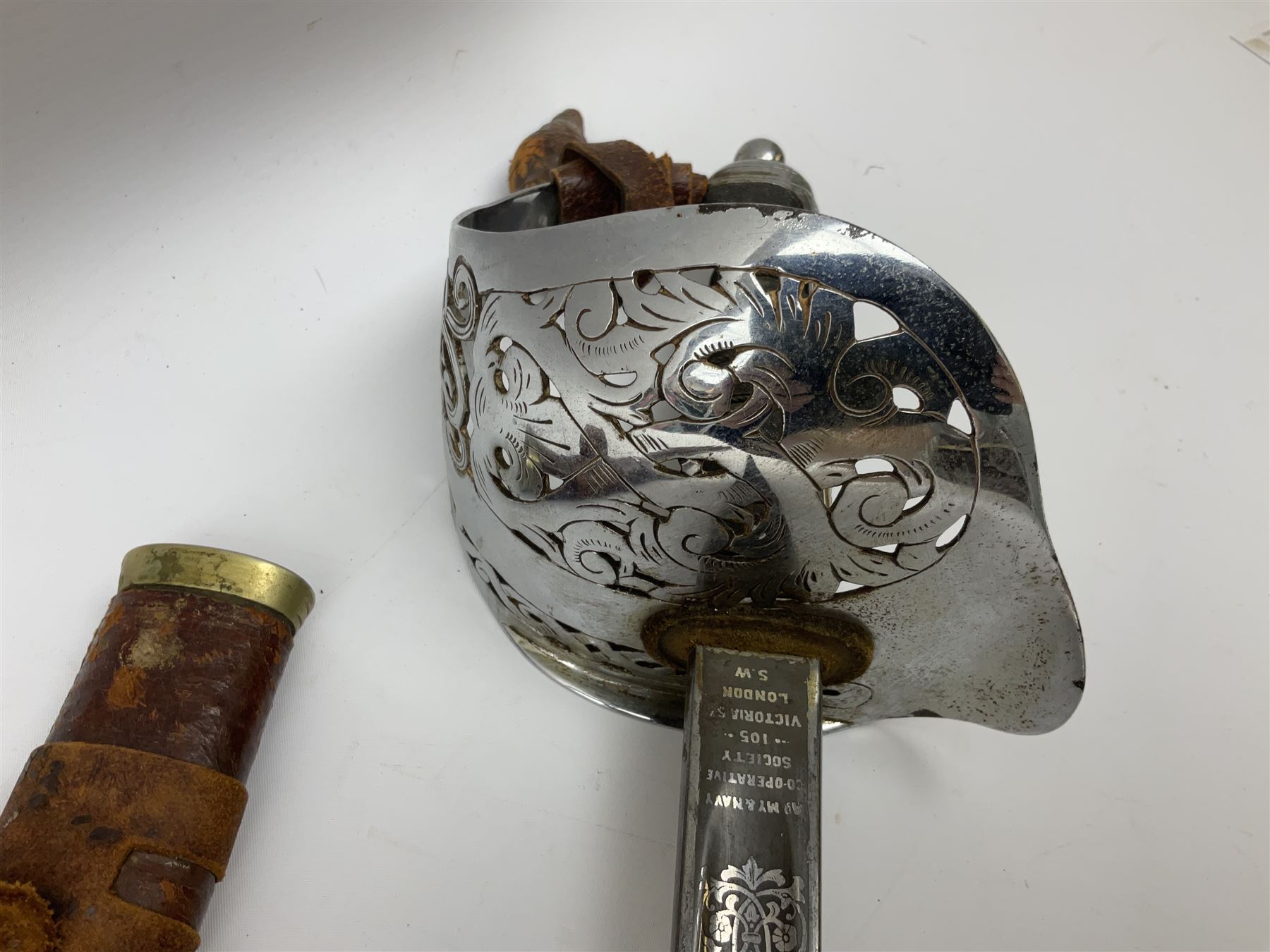 British George V 1897 Pattern Infantry Officers Sword, the 82.5cm fullered steel blade etched and polished with crowned royal arms, GRV cyphers and scrolling foliage, marked Army & Navy Co-operative Society 105 Victoria St London SW to the ricasso,  plated pierced basket hilt with wire bound fish skin grip and leather knot, No.15032; in leather covered scabbard