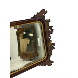 Early 20th century walnut Chippendale design wall mirror, shaped fretwork frame carved and pierced with Ho Ho bird, foliate carved inner slip enclosing plain mirror plate (71cm x 67cm); together with a similar Chippendale design mirror (A/F) (85cm x 49cm)