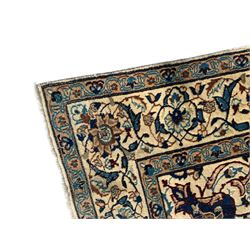Persian Kashan ivory ground rug, wool with silk inlay, central floral rosette medallion surrounded by trailing flower heads and interlacing leafy branches, the repeating scrolling border decorated with palmettes, within guard stripes