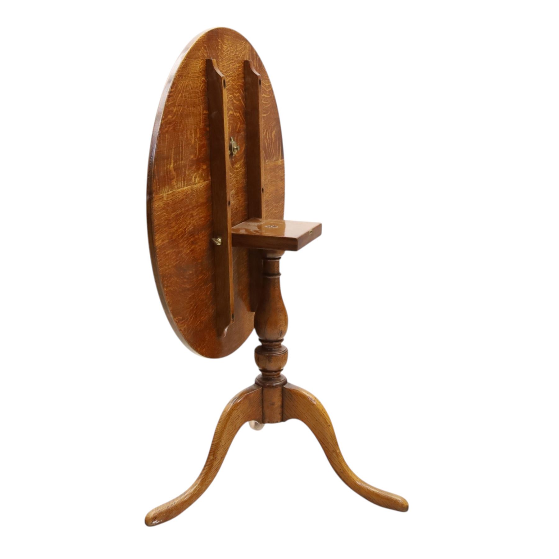 Traditional design golden oak tilt-top tripod table, brass fittings, turned baluster column on splayed supports