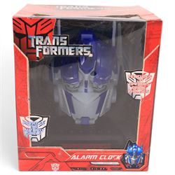First 4 Figures Transformers Optimus Prime vs. Megatron model, together with a Hasbro Transformers Bumble Bee bust and a Hasbro Transformers Alarm Clock, all boxed