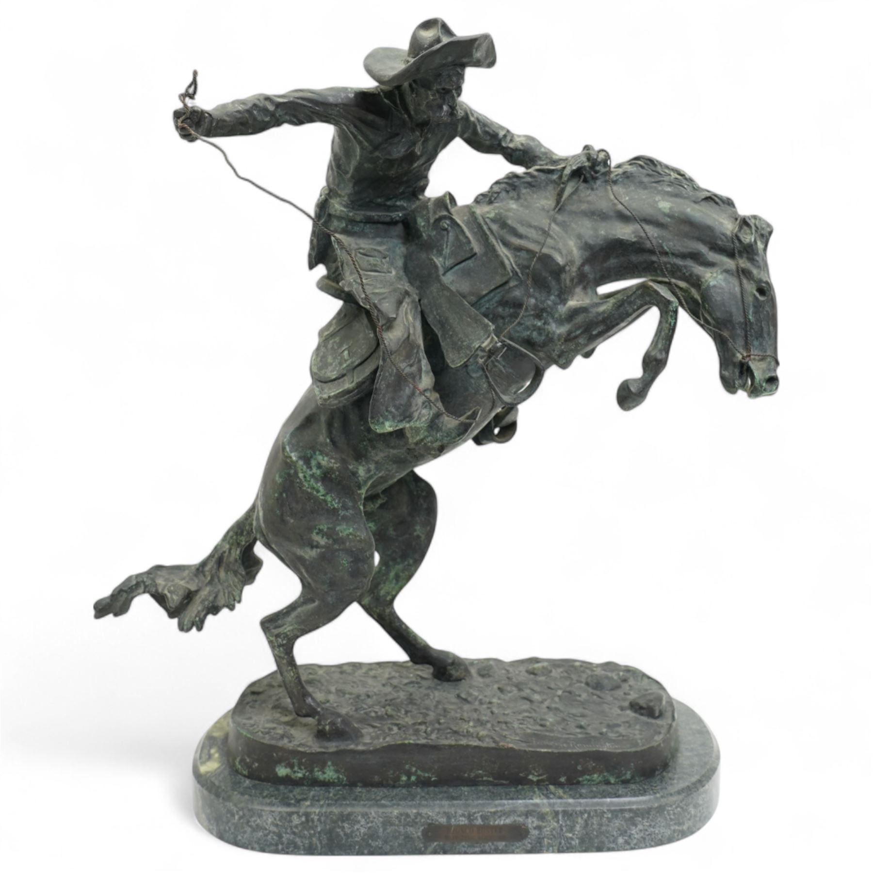 After Frederick Remington (American 1861-1909): 'Bronco Buster', limited edition bronze bearing signature and numbered 7/100, with foundry or ranch mark to horses backside of a triangle within circle, on green marble base, H56cm
