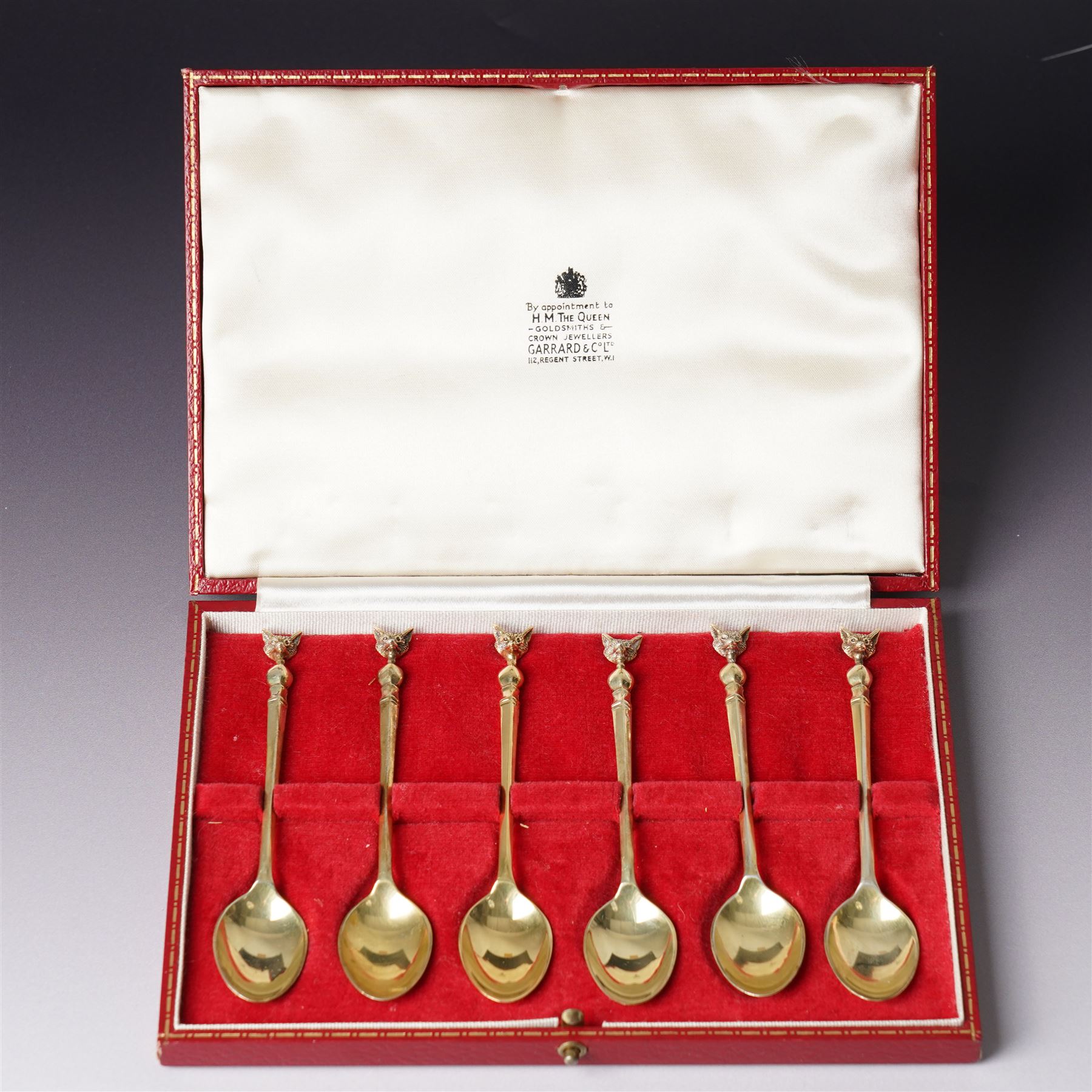 Cased set of six silver gilt coffee spoons with fox mask terminals London 1973 Maker S J Rose & Son in Garrards case