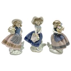 Three Lladro Flower Girls figures, comprising Sweet Scent no 5221, Pretty Pickings no 5222 and Spring is Here no 5223, largest example H18cm 