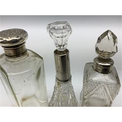 Quantity of glass scent bottles and dressing table jars to include seven hallmarked silver collared and lidded examples, to include collared example stamped Birmingham 1910, along with similar metal mounted examples 