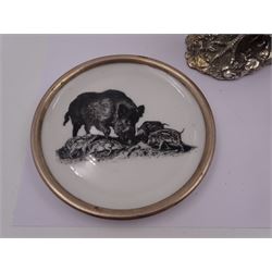 Pair of German plates, each with transfer printed wild boar decoration and silver rims, together with a silver filled model of a pheasant after Genty, hallmarked