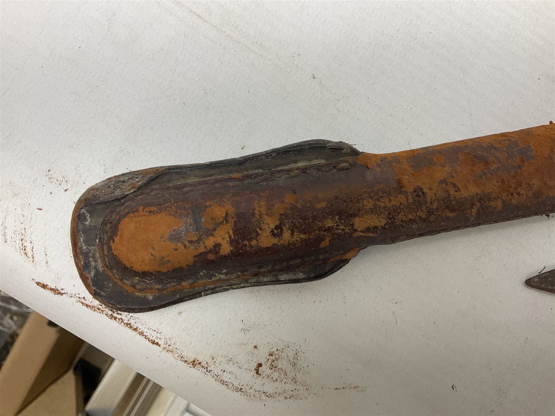 George V 1897 pattern Infantry officers sword, the 82cm single fullered blade with traces of etched detail and George V crown cipher, the ricasso marked Hawksworth Sheffield, pierced half basket hilt with George V cypher, wire-bound fish-skin grip with brass pommel and backstrap; in leather scabbard L102cm overall; together with two sectional gun cleaning rods; swagger stick made of leather strips etc