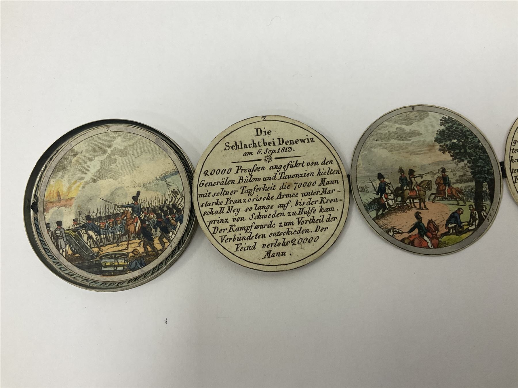 Grolier Club’s silver Schraubmedaille to commemorate the German campaign of 1813, obverse depicts a Greek temple, below “Eintracht Überwindet Alles”, the reverse depicts three figures and the text “Gerechtigkeit. Weisheit. U. Einigkeit. Beglücken. D.: Menschheit”, inside are twelve circular hand coloured engravings depicting six major battles of the German campaign, each with corresponding descriptions, D