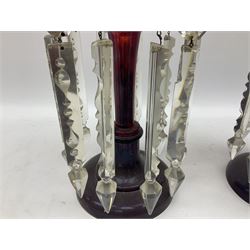 Pair of Victorian ruby glass lustre vases, each with hollow baluster stem, and domed base, hung with prism drops and lozenges, H31cm