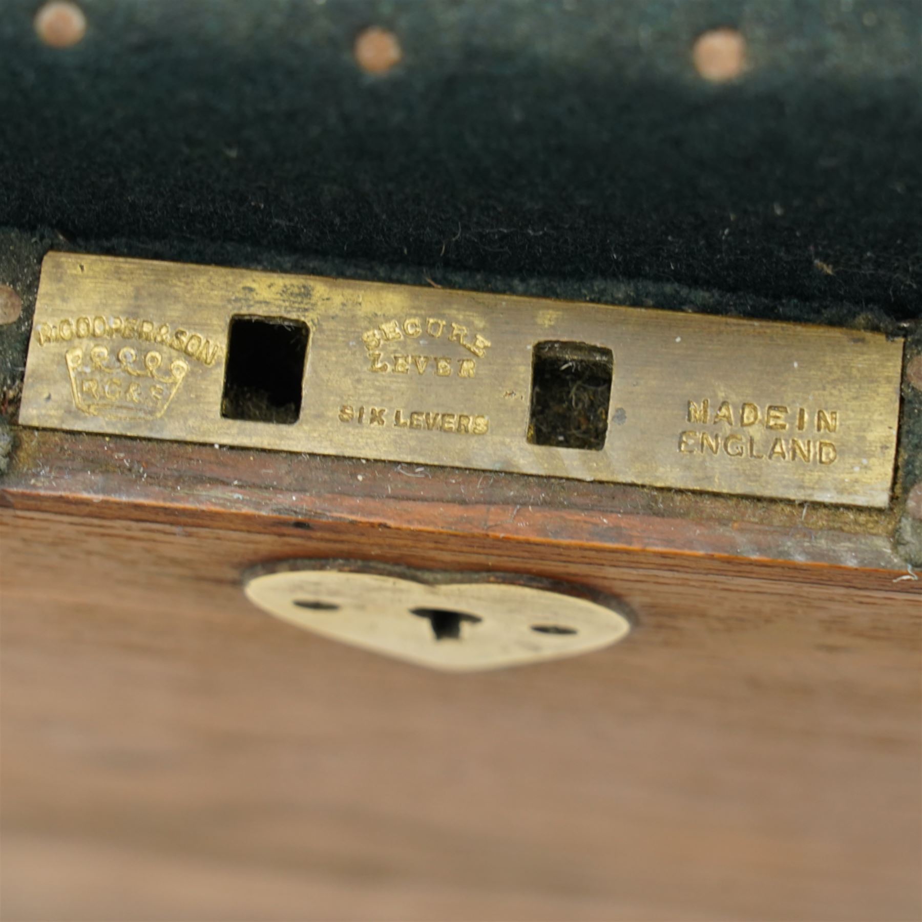 Early 19th century teak and brass bound silver campaign chest, fitted with brass L-shaped brackets and heavy weight carrying handles, the hinged lid enclosing two removeable trays with divisions and lined in blue baize, fitted with two 'R. Cooper & Son' brass locks