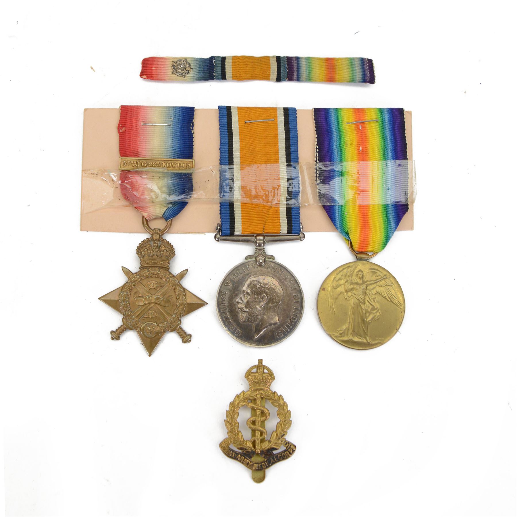 WWI trio of medals, comprising British War Medal, Victory Medal, 1914-15 Star with clasp, awarded to '1623 Pte W. Atkinson Royal Army Medical Corp, together with Royal Army Medical Corp cap badge 
