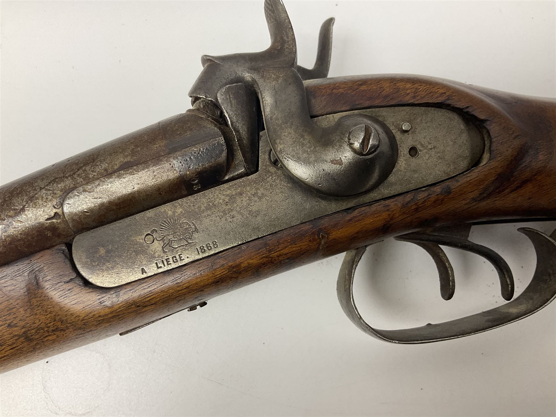 19th century Indian .577 Enfield muzzle loading rifle, proofed for 26-bore, the 98.5cm barrel with three barrel bands and later ram rod L140cm overall; 19th century Belgian side-by-side double barrel percussion shotgun, approximately 20-bore, with 74cm barrels and studded walnut stock, lock plate marked 'Liege 1868' and 'V. Gulikers-Maquinay' L117cm overall; and another side-by-side double barrel shotgun by Smythe with underlever opening (3)