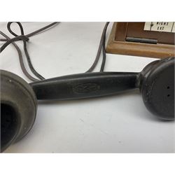 Early-mid 20th century internal telephone system, comprising exchange box with attached TMC rotary telephone and dictograph with Bakelite handset and support upon stained wood case, and 1960s black Bakelite telephone model 312L with G.P.O sticker beneath, largest H30.5cm W36.5cm D30cm