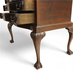 20th century oak and mahogany serpentine chest, the moulded top carved with trailing crossed ribbon and flower heads, fitted with three long cock-beaded drawers, ornate cast gilt metal handles, on acanthus leaf carved cabriole supports with ball and claw feet 