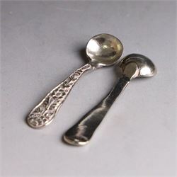 Pair of Middle Eastern silver cruets, of spherical form with pierced tops, embossed with figures, elephants and village scenes, unmarked, together with a pair of silver condiment spoons embossed with floral decoration 