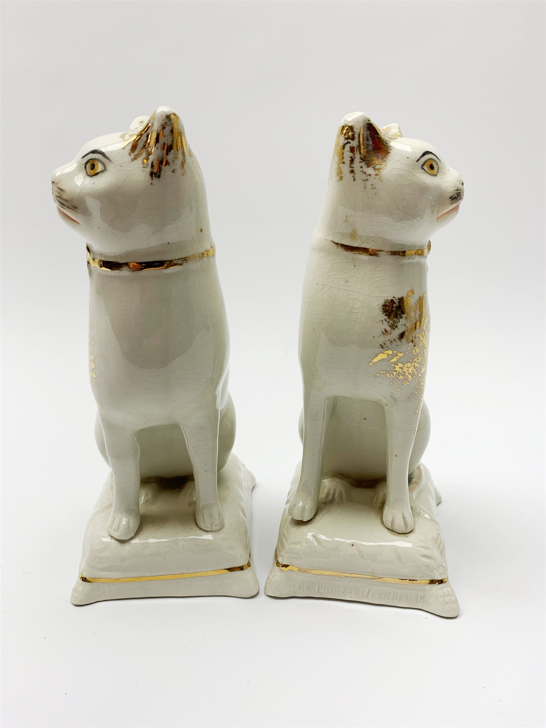 Pair of Victorian Staffordshire cats, modelled seated upon cushions, with gilt detail throughout, H18cm