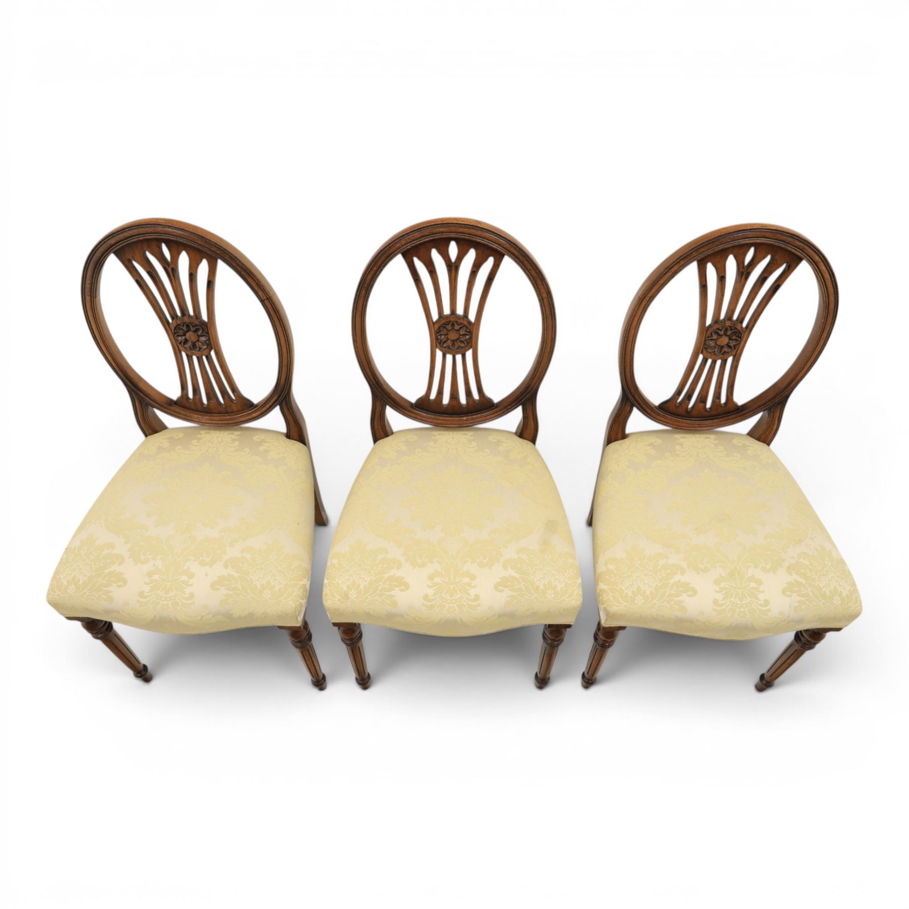 Bevan Funnell Reprodux - Regency design set of ten mahogany dining chairs, oval backs with central splat with rose motif, serpentine seat upholstered in damask fabric, raised on turned supports