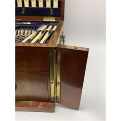 Late 19th/early 20th century composite canteen of silver flatware, contained within an early 20th century mahogany serpentine fronted case with twin drop carry handles, and hinged cover with boxwood stringing and central inlaid shell motif, above a single drawer with twin ring handles and Wellington style locking system, the cover and drawer opening to reveal plaque for Spink & Sons Ltd London, and fitted interior containing ivory handled knives, ivory handled carving set, and silver Hanoverian and Old English pattern cutlery, each with engraved monogram to terminal, hallmarked London, makers Spink & Son (John Marshall Spink), Goldsmiths & Silversmiths Co, and Chawner & Co (George William Adams), various dates ranging 1880-1923, gross weighable silver 92.59 ozt (2880 grams)